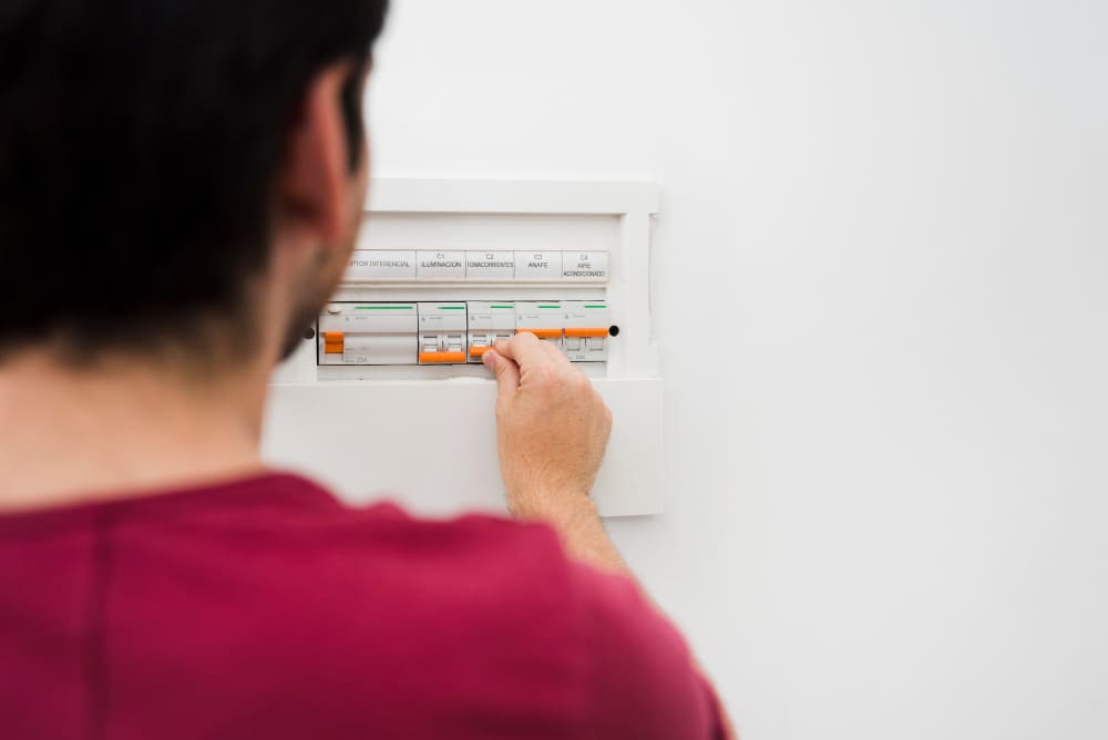 man-switching-off-electric-fuse-electrical-box-wall man-switching-off-electric-fuse-electrical-box-wall